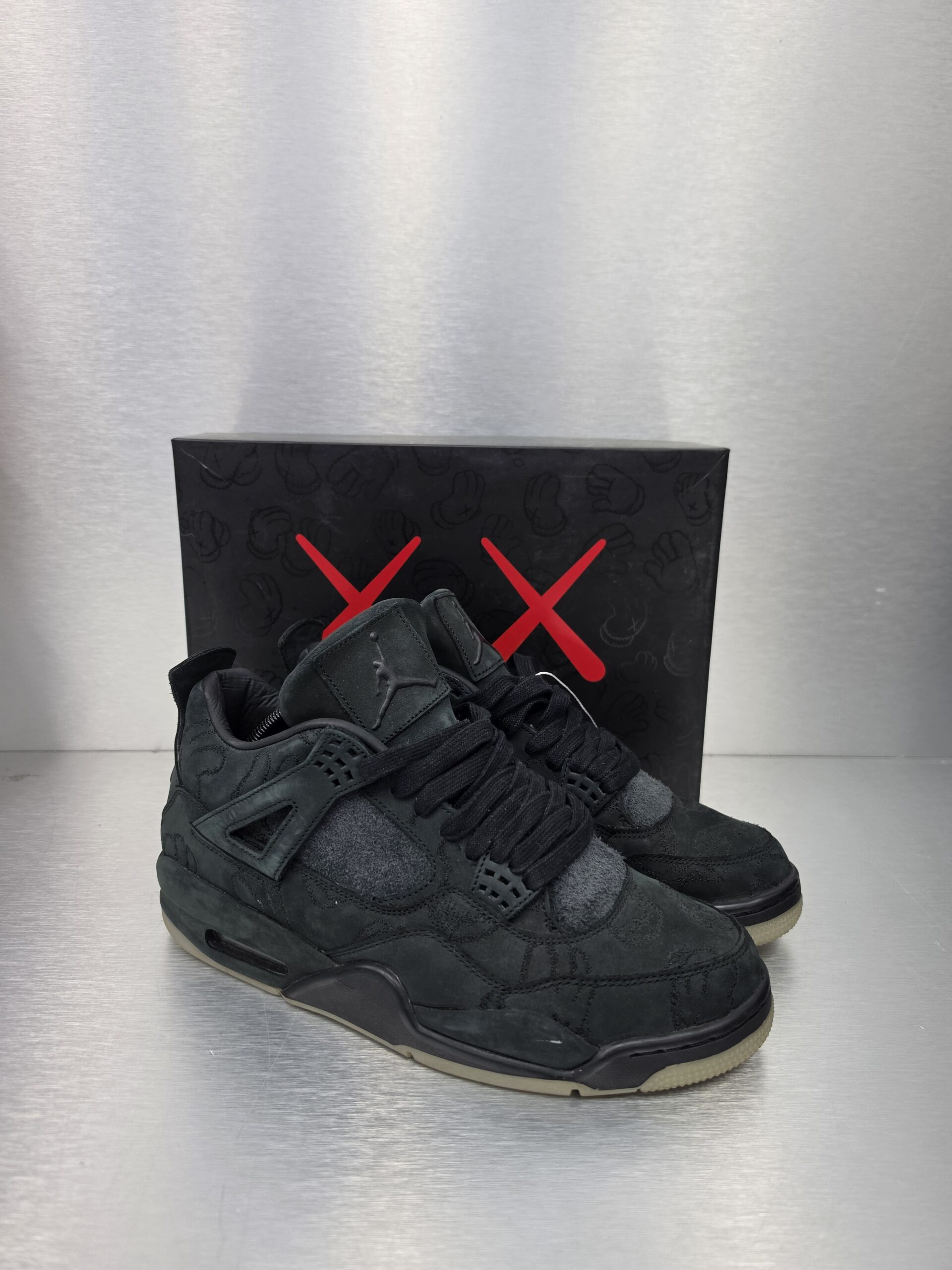 KAWS x Air Jordan 4 Retro 'Black' – side view