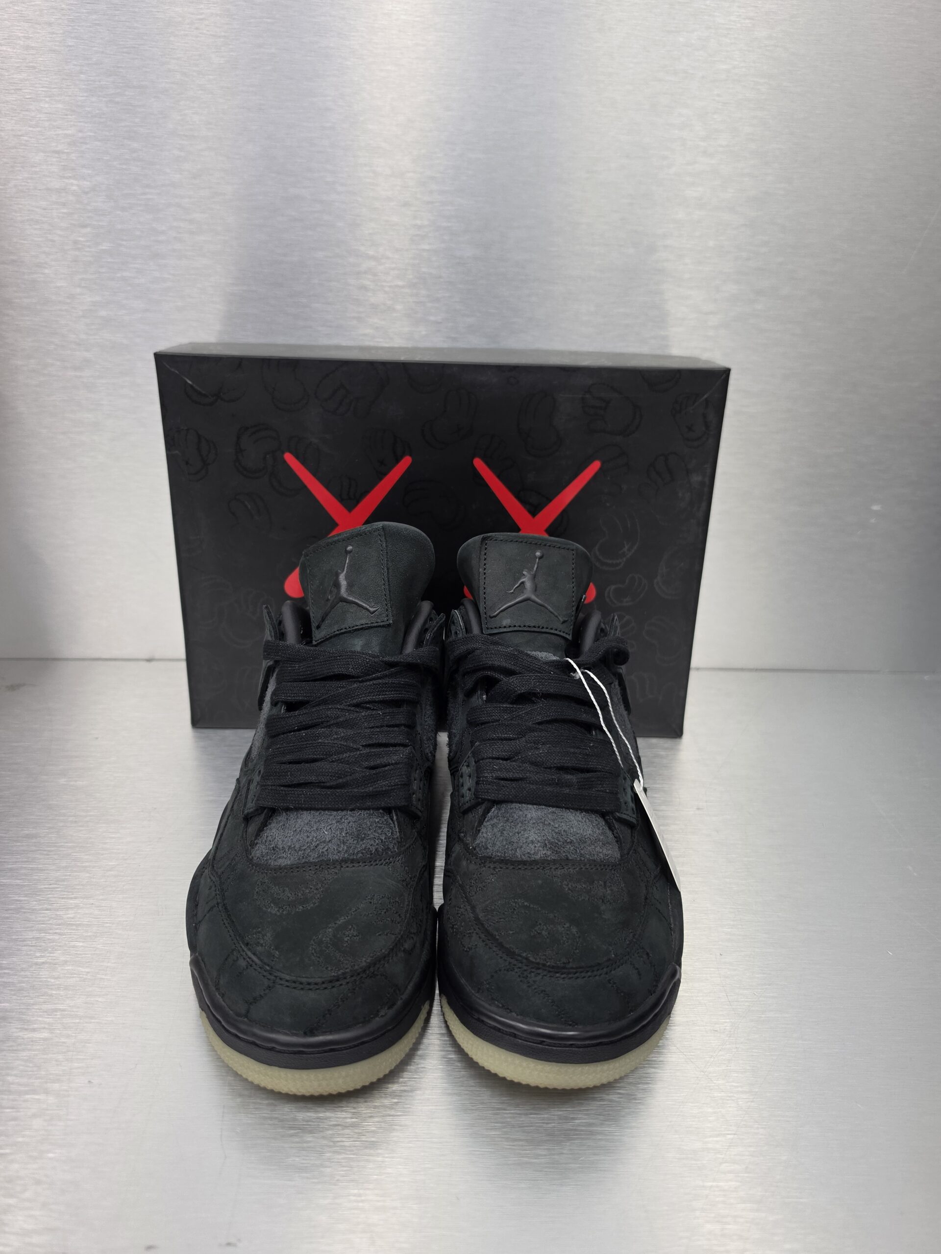 KAWS x Air Jordan 4 Retro 'Black' – front view
